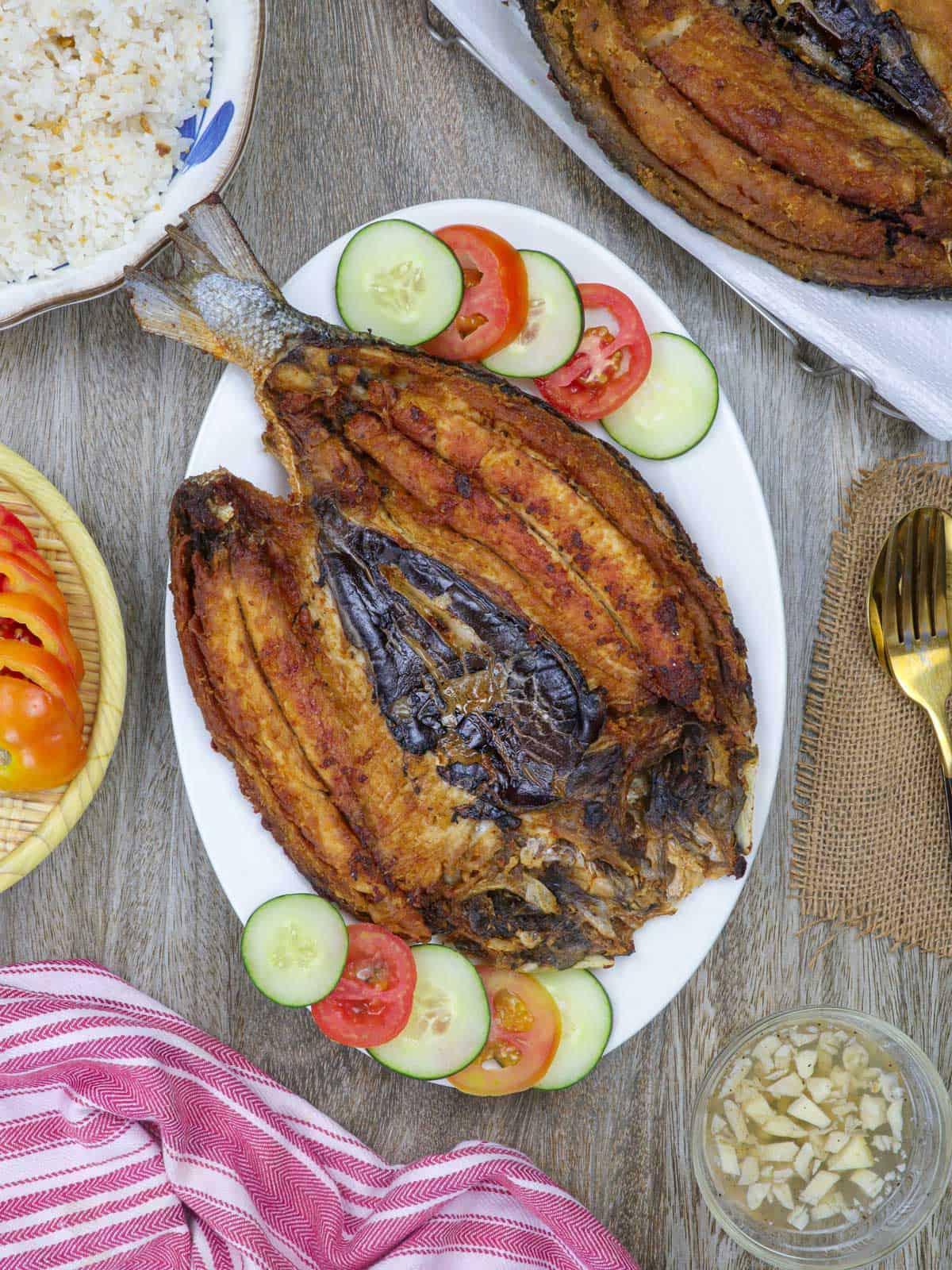 daing na bangus on a white serving platter.